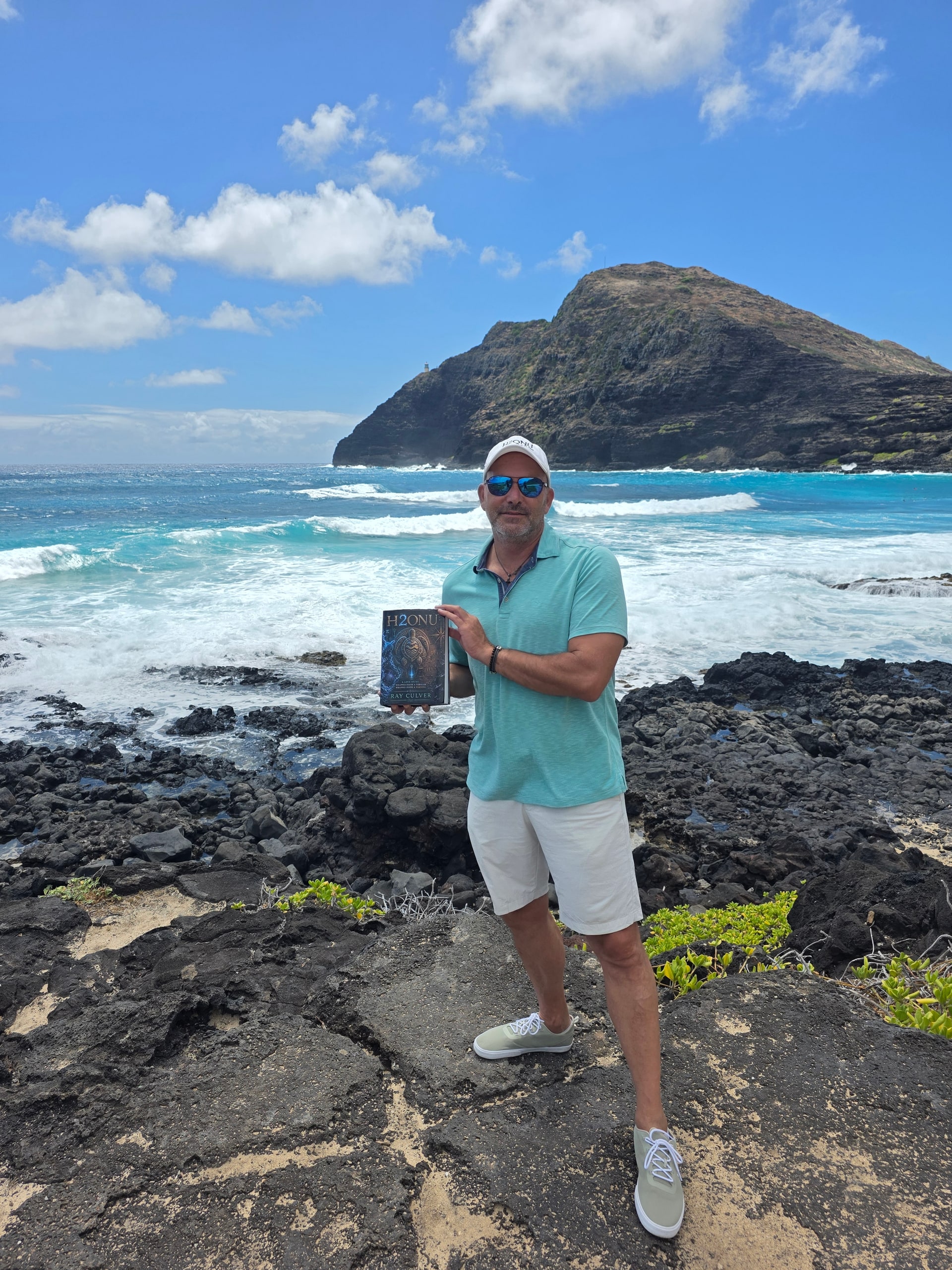 Author Ray Culver holding the H2ONU First Edition at Makapuʻu, Oʻahu