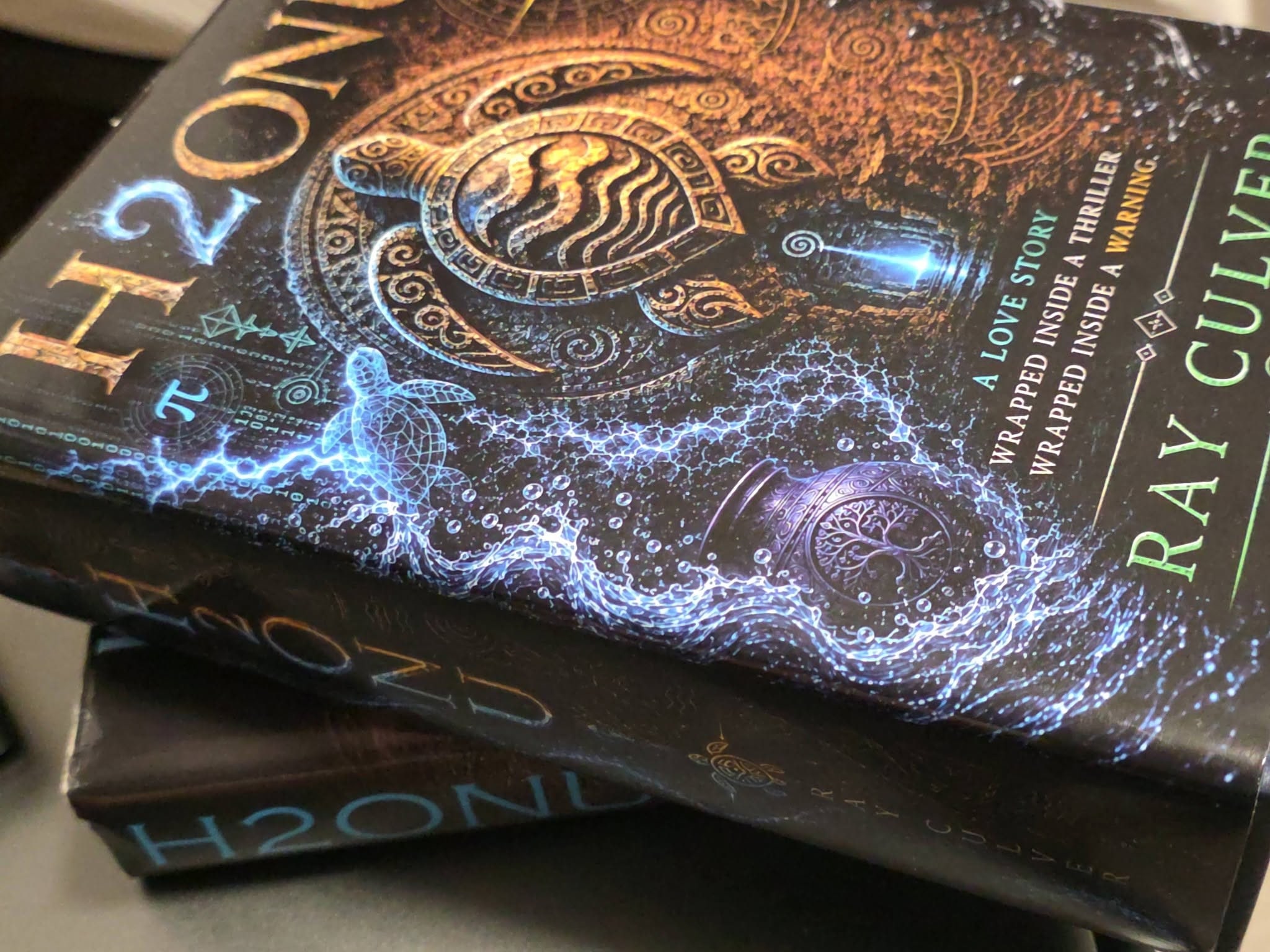 Macro of two stacked H2ONU First Edition hardcovers